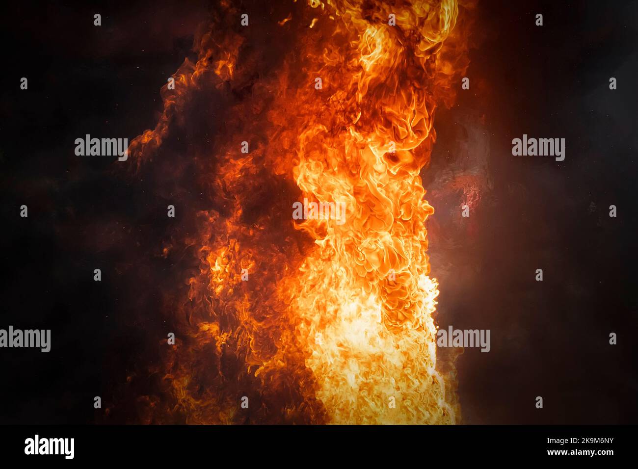 a strong bright flame of fire on a dark background Stock Photo - Alamy