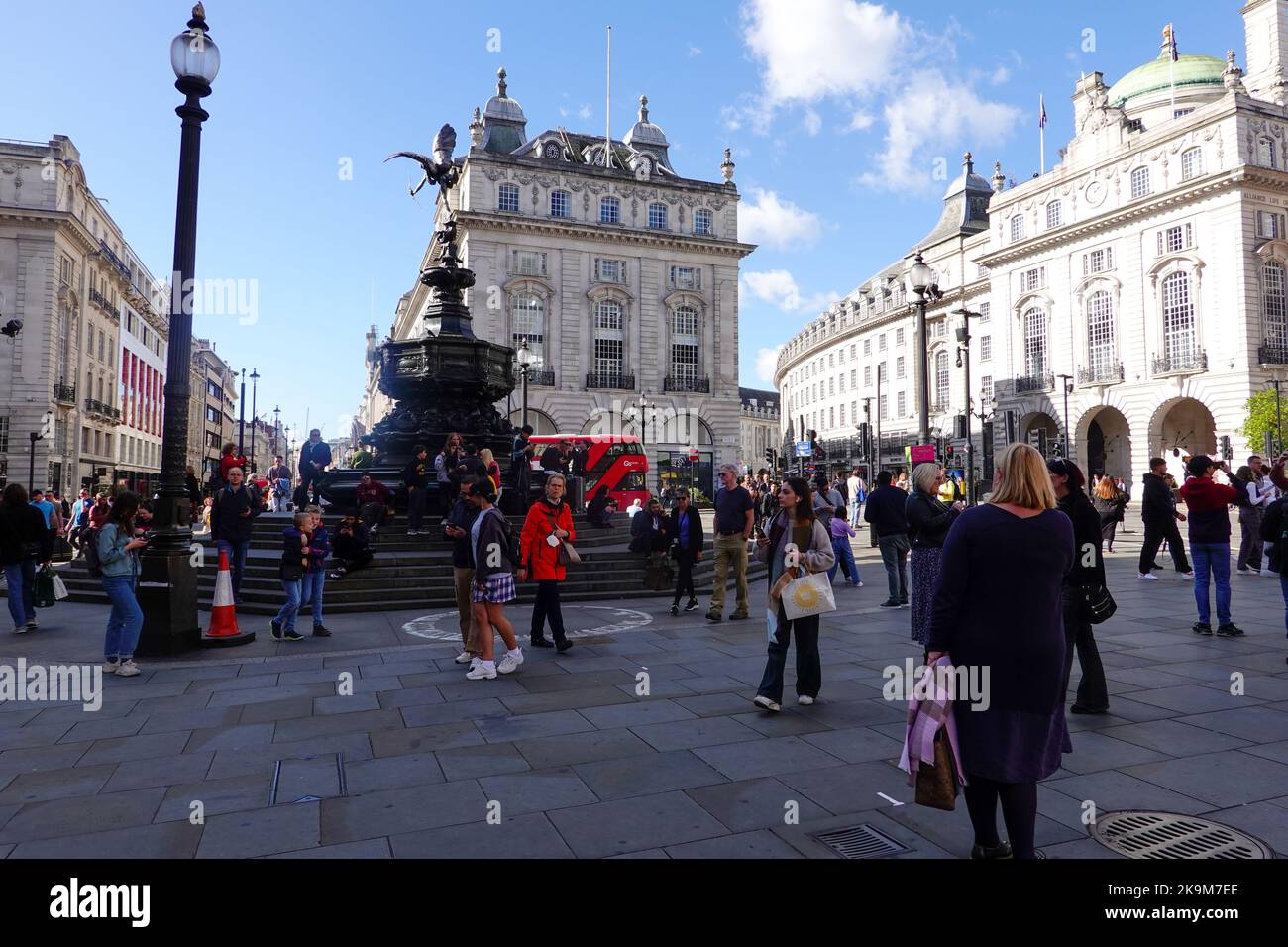 People at Shaftesbury Memorial Fountain, surmounted by a winged statue of Anteros, located at the southeastern side of Piccadilly Circus London. Stock Photo