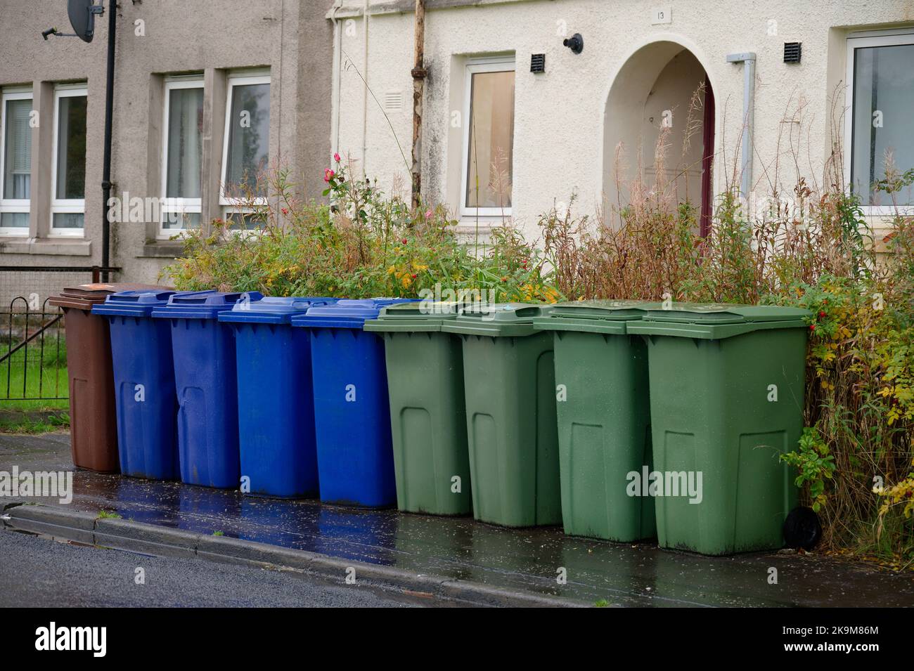 Wheelie bins in row for refuge collection outside council residential