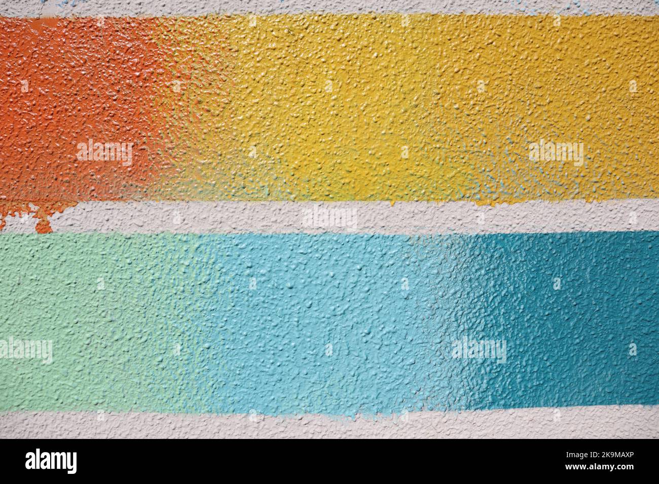 Striped Textured Multi-Color lines on a Wall - Yellow Orange Teal Baby Blue Turquoise with a Smudge Stock Photo