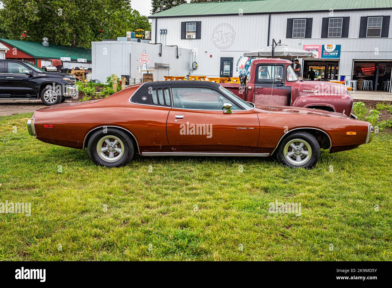 Des Moines, IA - July 01, 2022: High perspective side view of a 1973 Dodge Charger Hardtop Coupe at a local car show. Stock Photo