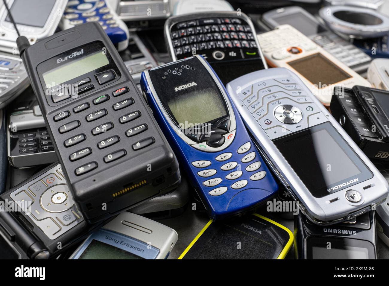 Prague, CZ - 12 December 2021:  A heap of Various brand old mobile phones with media enabled. Many types and generations of  mobile smartphone gadgets Stock Photo