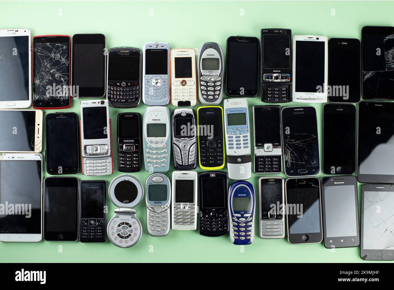 Prague, CZ - 02 November 2020:  A lot of Various brand old mobile phones with media enabled. Many types and generations of  mobile smartphone gadgets. Stock Photo