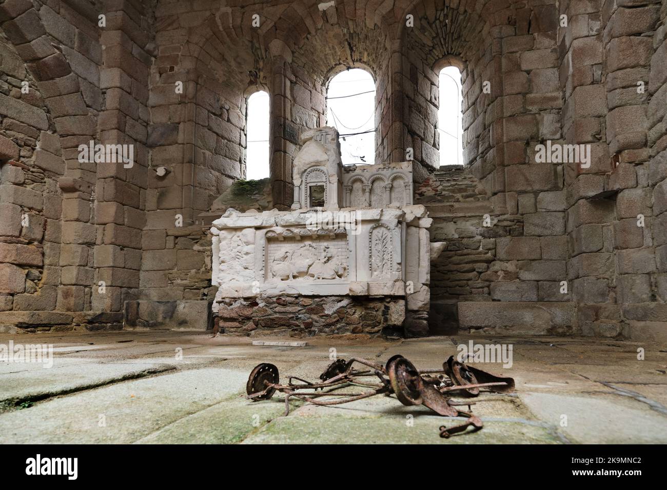 The Remains of a Childs Pram and the Bullet Scarred Alter Behind in the Church of Oradour-sur-Glane in the Haute-Vienne, France Stock Photo