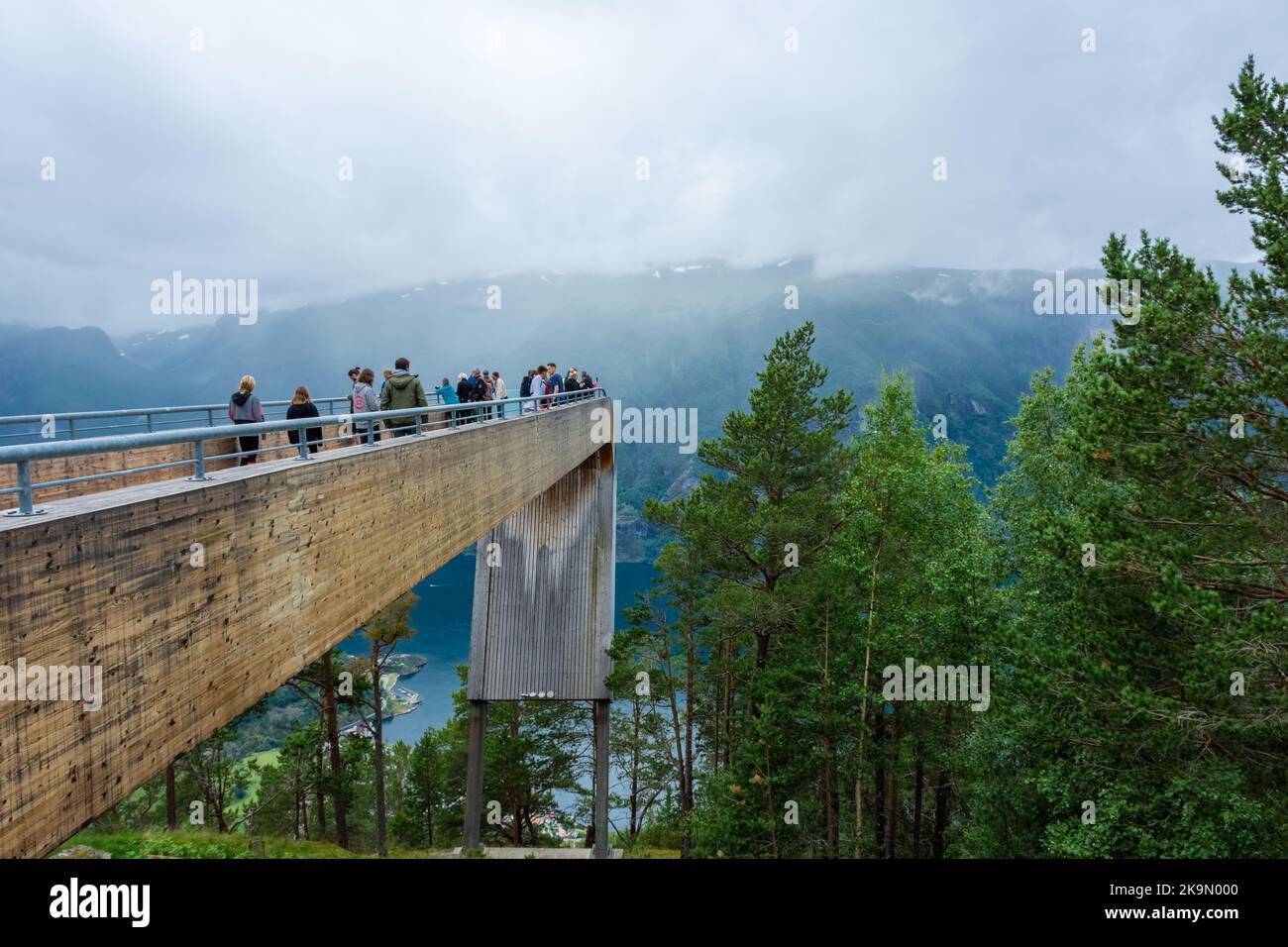 Aurland, Norway, 9 August 2022: Tourists admiring the landscape from the Impressive wooden platform for a lookout over the fjord of Aurland in Stegast Stock Photo