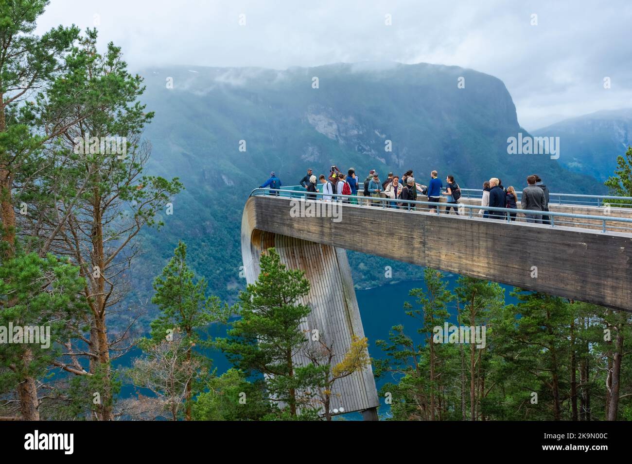 Aurland, Norway, 9 August 2022: Tourists admiring the landscape from the Impressive wooden platform for a lookout over the fjord of Aurland in Stegast Stock Photo