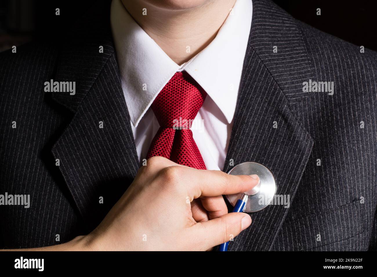 Businessman stethoscope examination on chest Stock Photo Alamy
