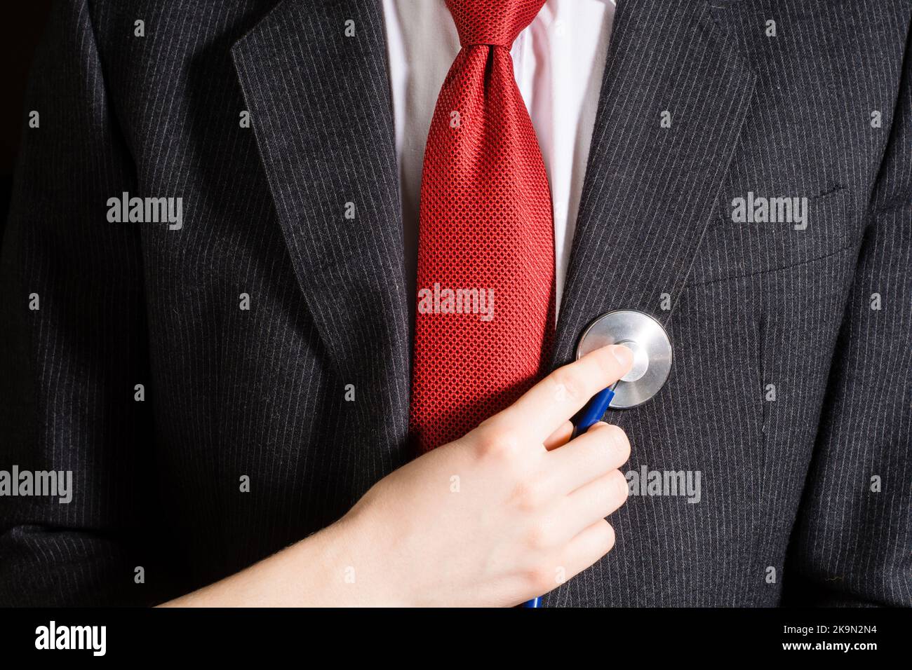 Businessman stethoscope examination on chest Stock Photo Alamy
