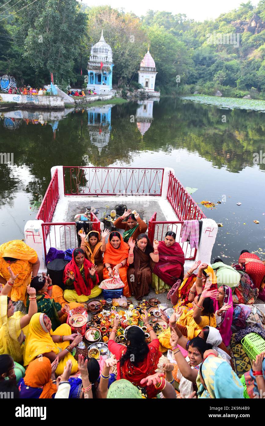 Women Jalabhishek of Laddu Gopal and perform rituals at the Devtal lake on the holy month of Kartik in Jabalpur. Photo By - Uma Shankar Mishra Stock Photo
