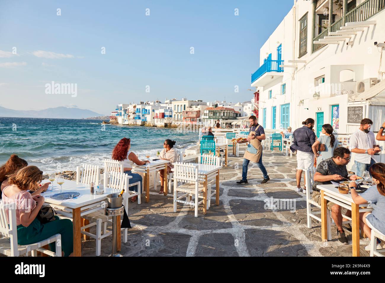 Mykonos island Tourists in bar at waterfront Stock Photo - Alamy