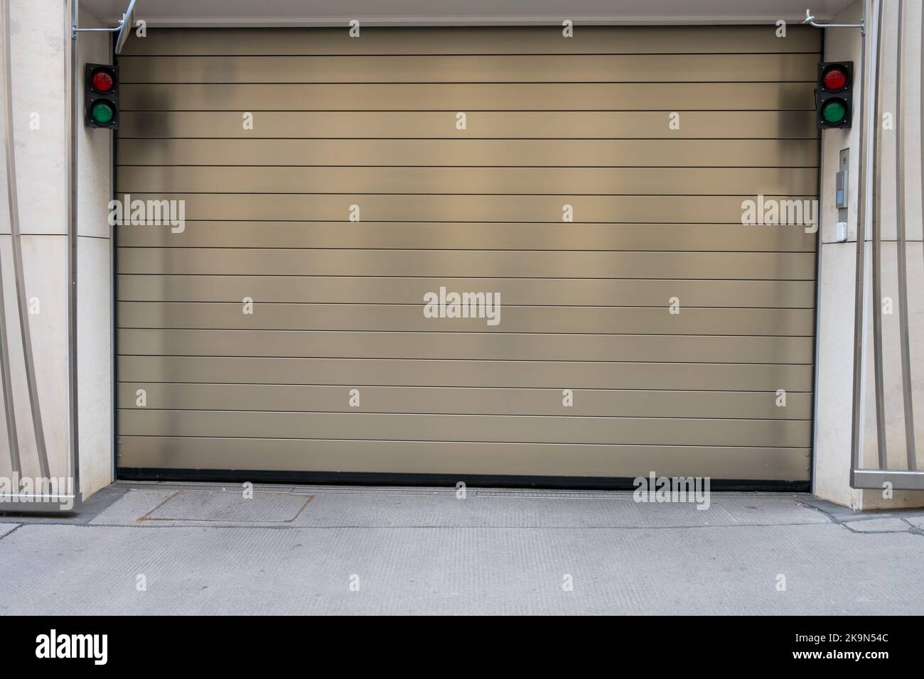 Close up of closed metal sectional storage garage door driveway with