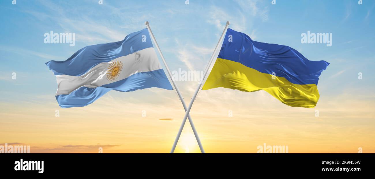 crossed national flags of Argentine and Ukraine flag waving in wind at ...