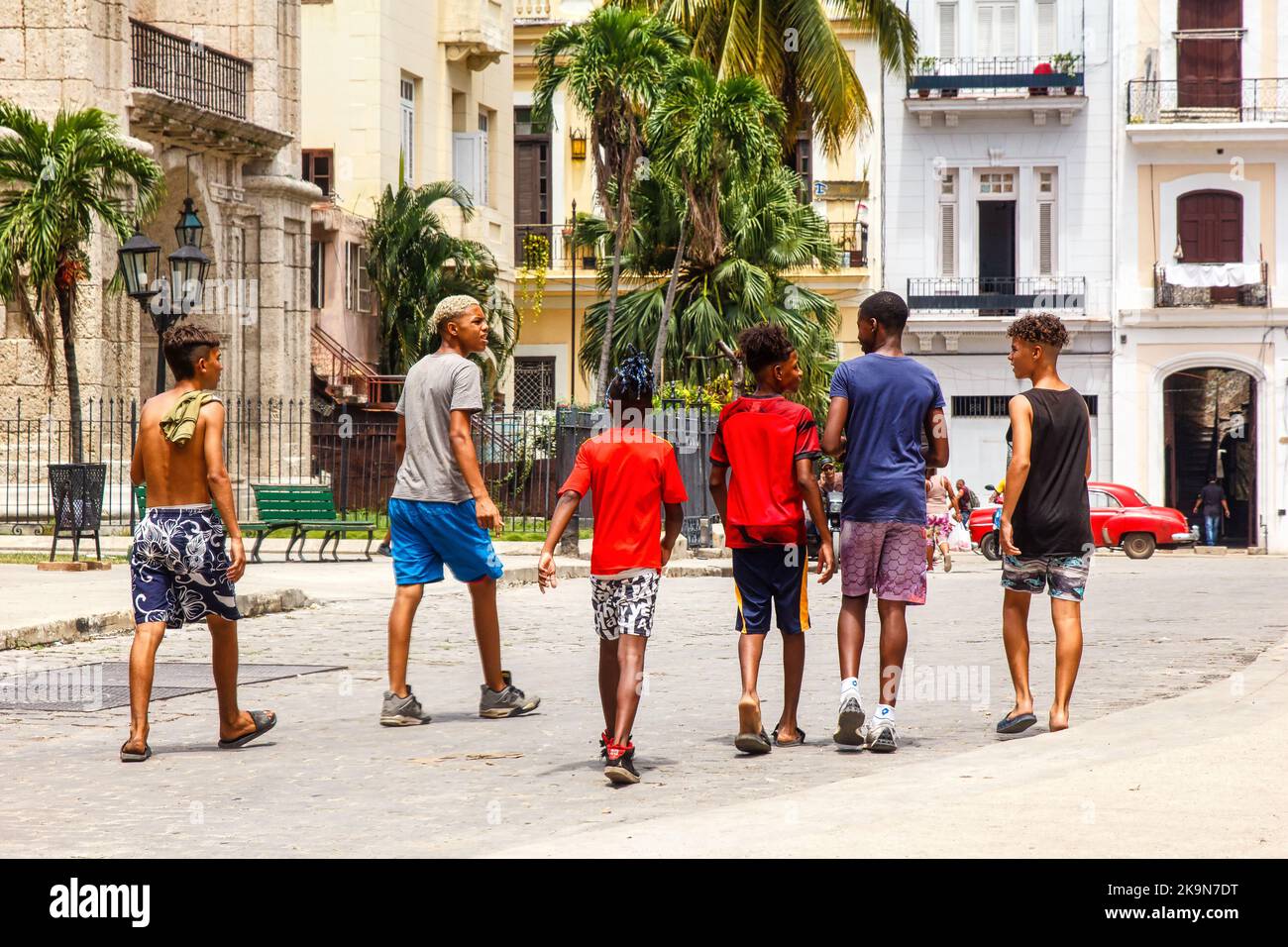 A group of young Cuban people walks in a city street. The image shows the lifestyle of the youth in the communist island Stock Photo
