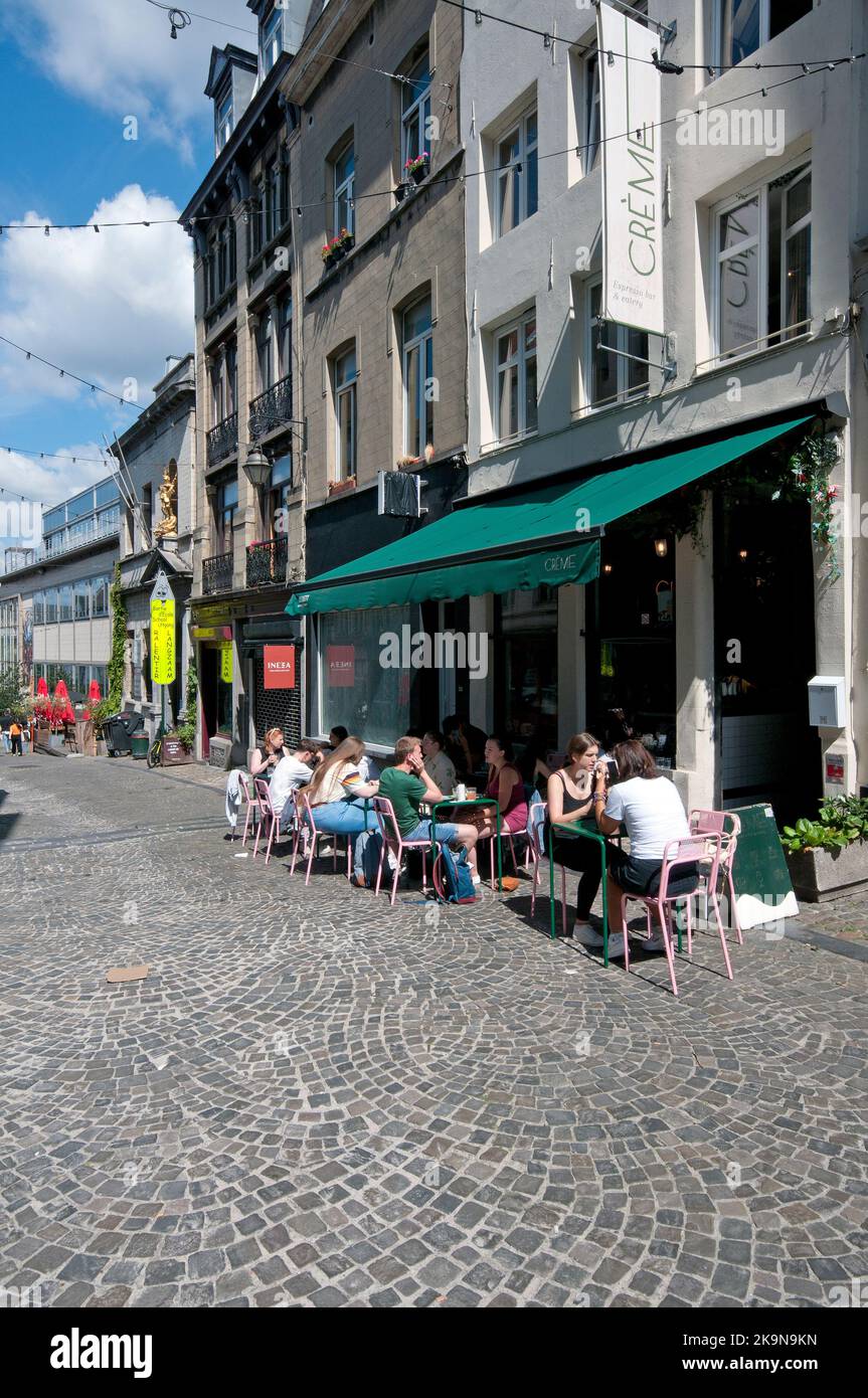 People sitting outside at Crème Cafè in Rue de Rollebeek 30, Brussels, Belgium Stock Photo