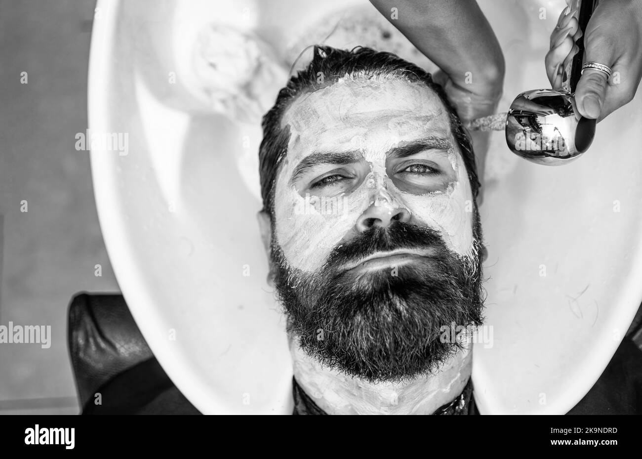 hair cut and beard care for caucasian guy in skincare Stock