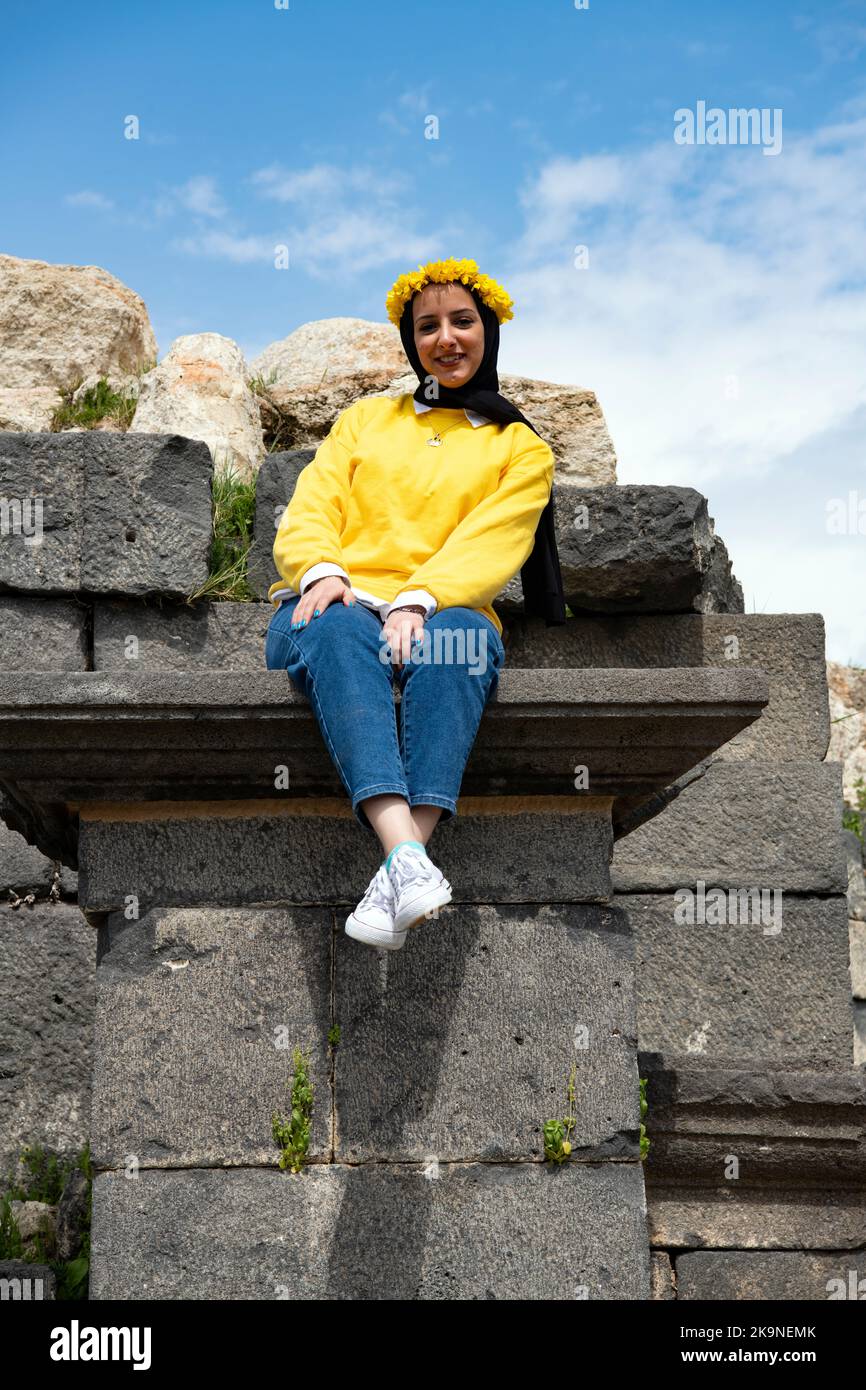 Pretty youg Jordan girl wearing Caeser yellow laurel wreath Umm Qais (Gadara) Jordan Stock Photo