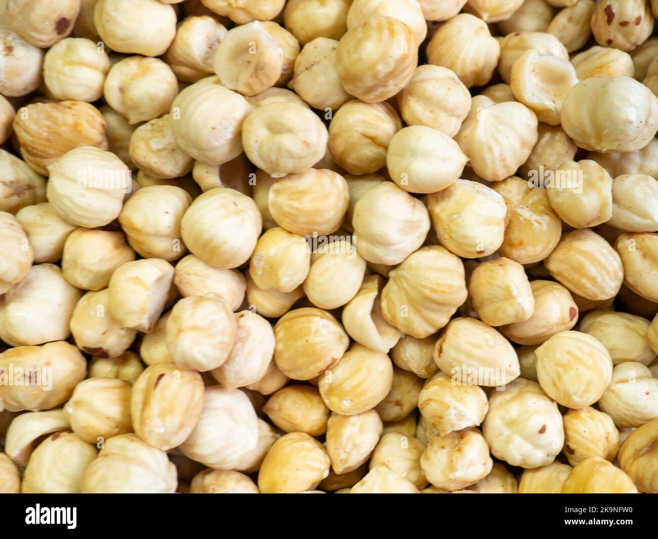 Shelled hazelnuts. Background of nuts without shells. Snack on the