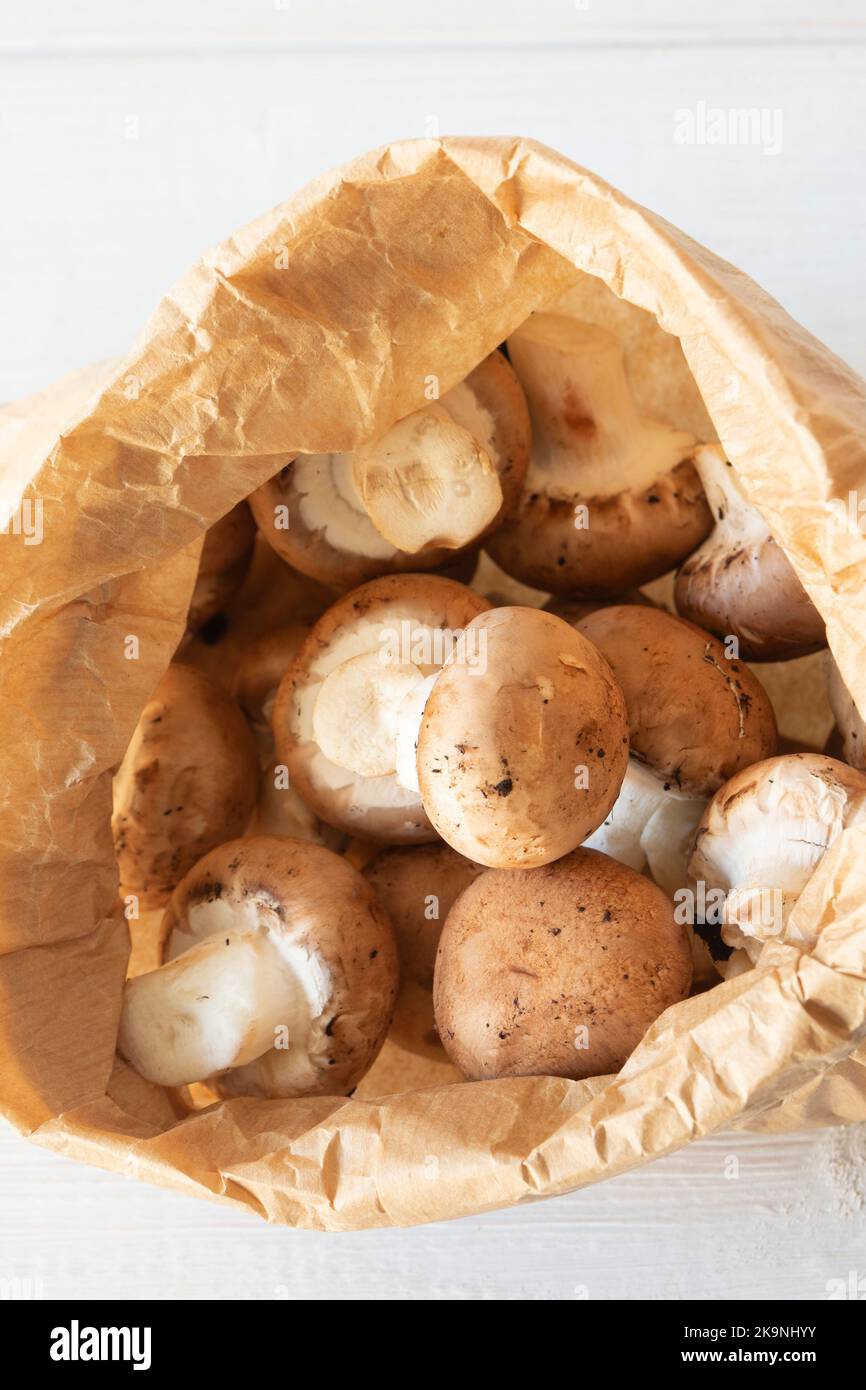 Chestnut mushrooms in a brown paper bag. Eco friendly recycling compostable packaging. Stock Photo