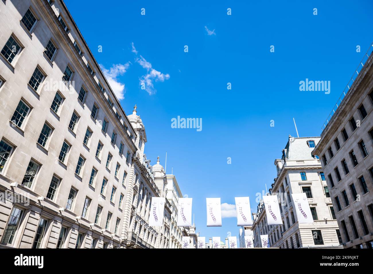 Looking up view on banners flags at Regent street road with Saint James's royal post office leading to Piccadilly circus in London, United Kingdom Stock Photo