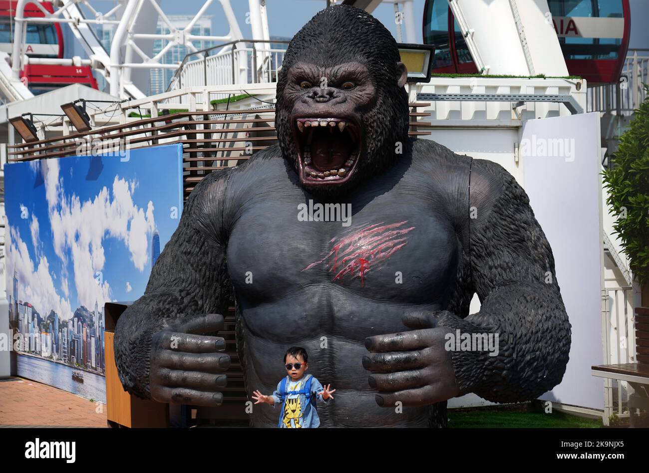 A boy poses for pictures with a gorilla sculpture in Central. 24OCT22 ...