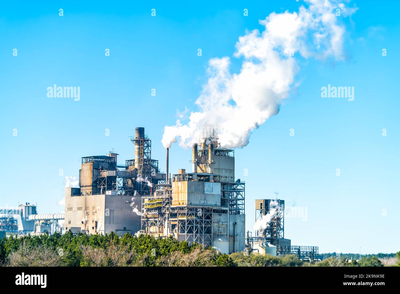 Industrial paper mill factory plant with chimney smokestacks stacks emitting carbon dioxide emission pollution in Georgetown, South Carolina town Stock Photo