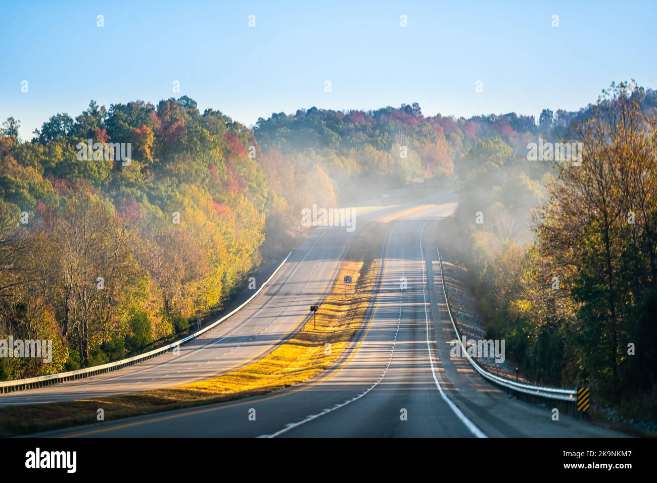 Fog mist covering forest trees at sunrise in West Virginia rural countryside by New River Gorge in morning autumn fall near interstate road highway 64 Stock Photo