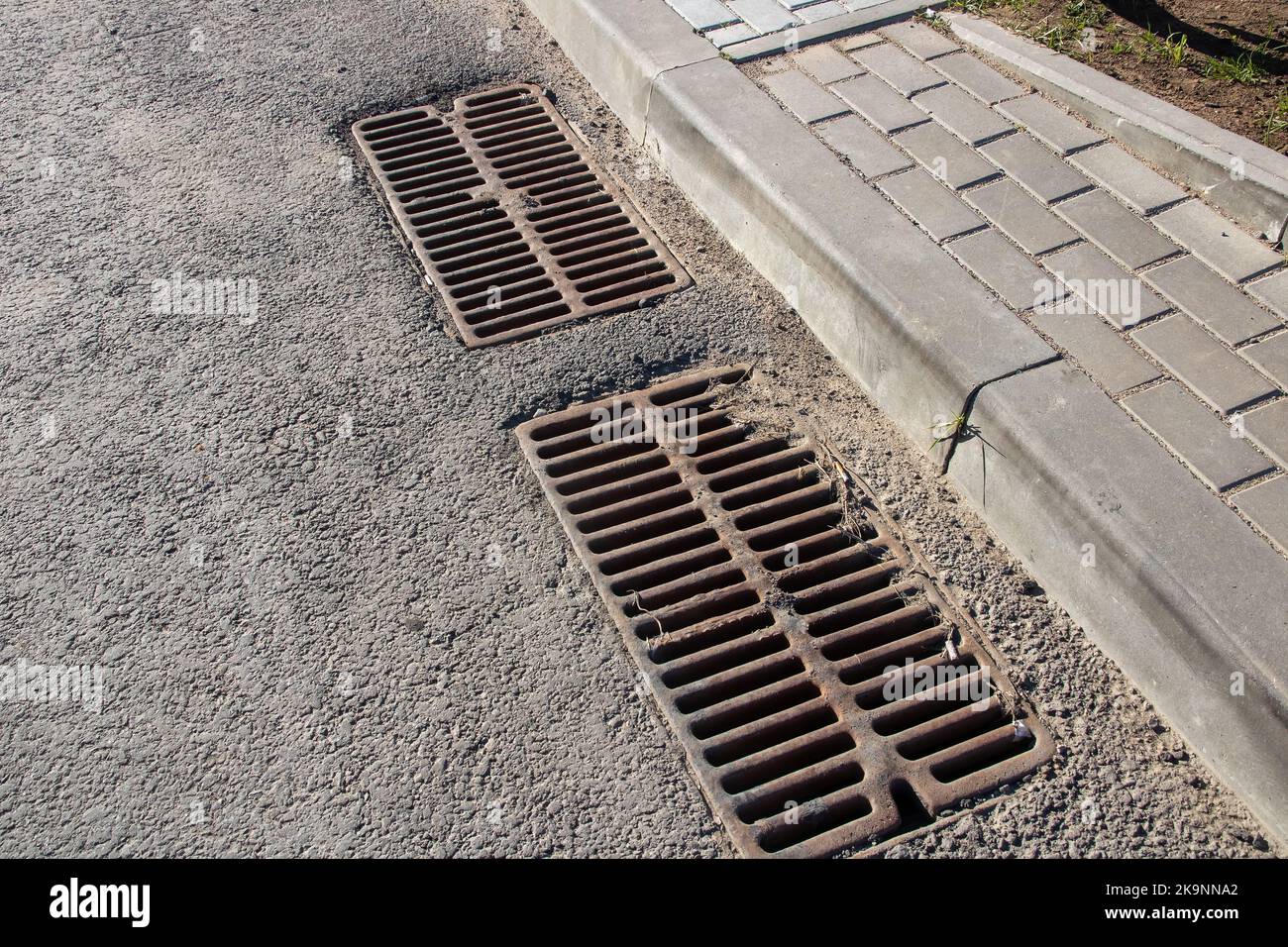 Long Grate Long sewer grate on gray asphalt close up Stock Photo - Alamy