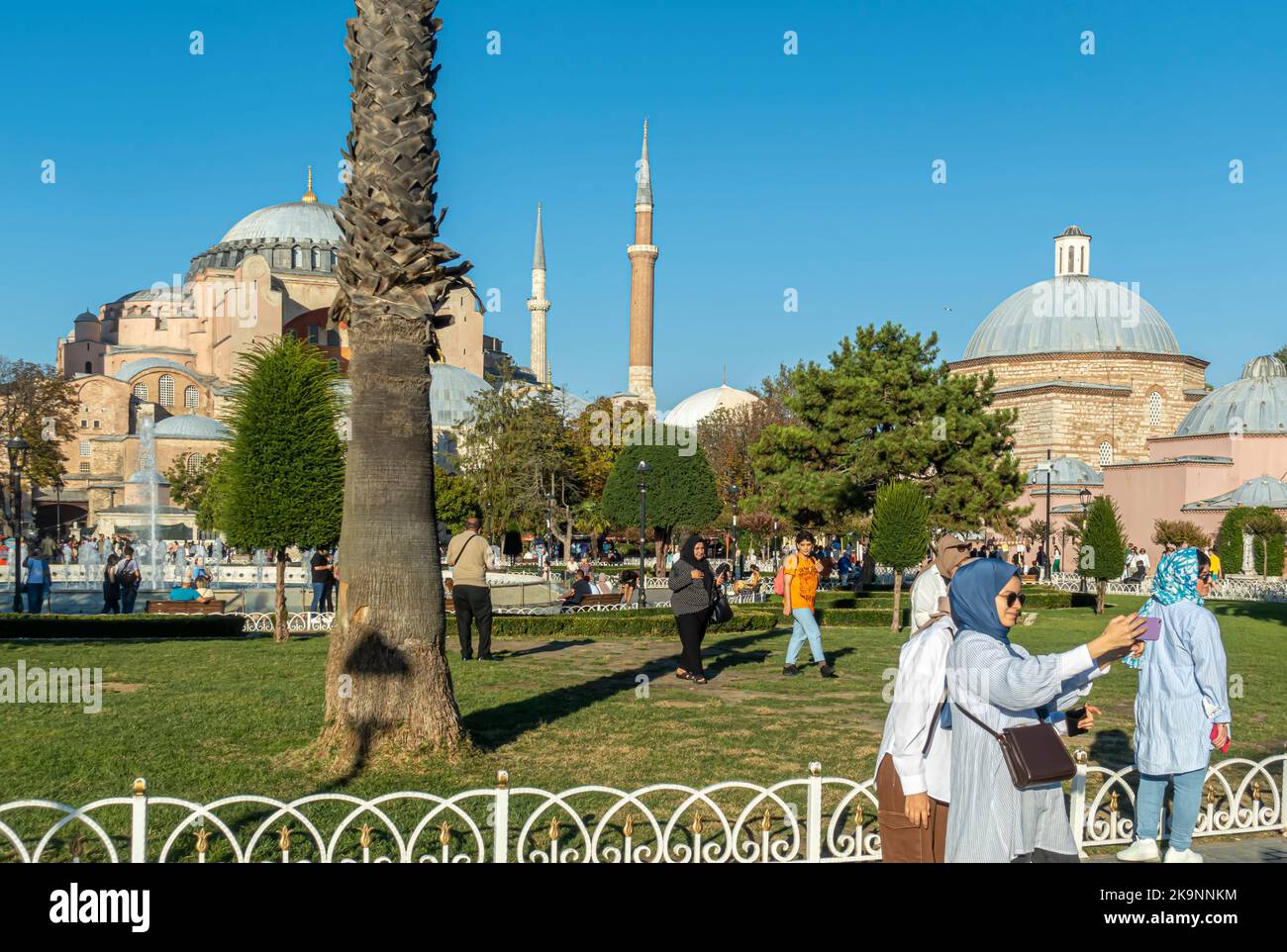 Turkish women taking selfie in Sultan Ahmet Parki with view of landmarks. Turkey woman doing selfies. Fatih, Istanbul, Turkey Stock Photo