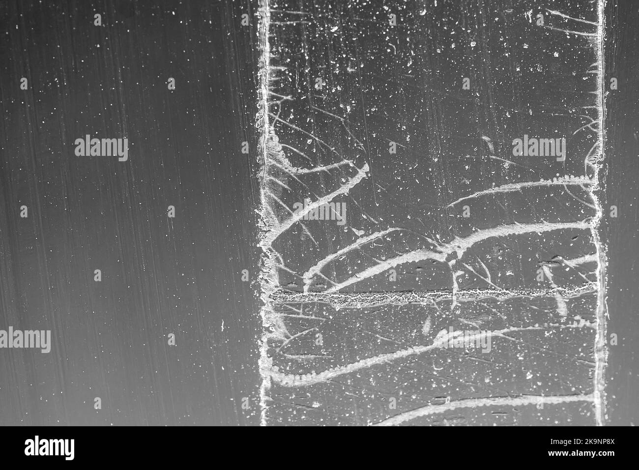 Strip of tape adhesive on a glass surface after being pulled Stock