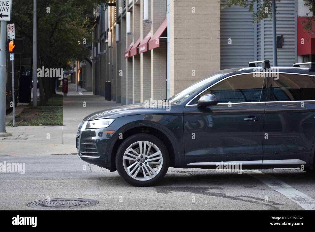 Houston, TX USA - October 8, 2022 - Audi midsized SUV cruising in downtown Houston's financial district pass the Phoenicia Super Market. Stock Photo