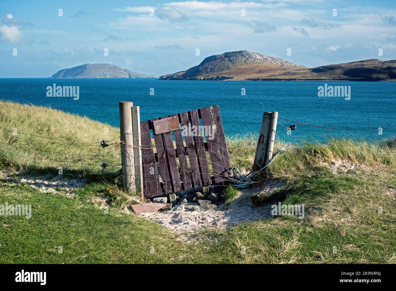 Broken gate leading to Traigh a Bhaigh (East Beach) on Vatersay in the Outer Hebrides, Scotland, UK. Stock Photo