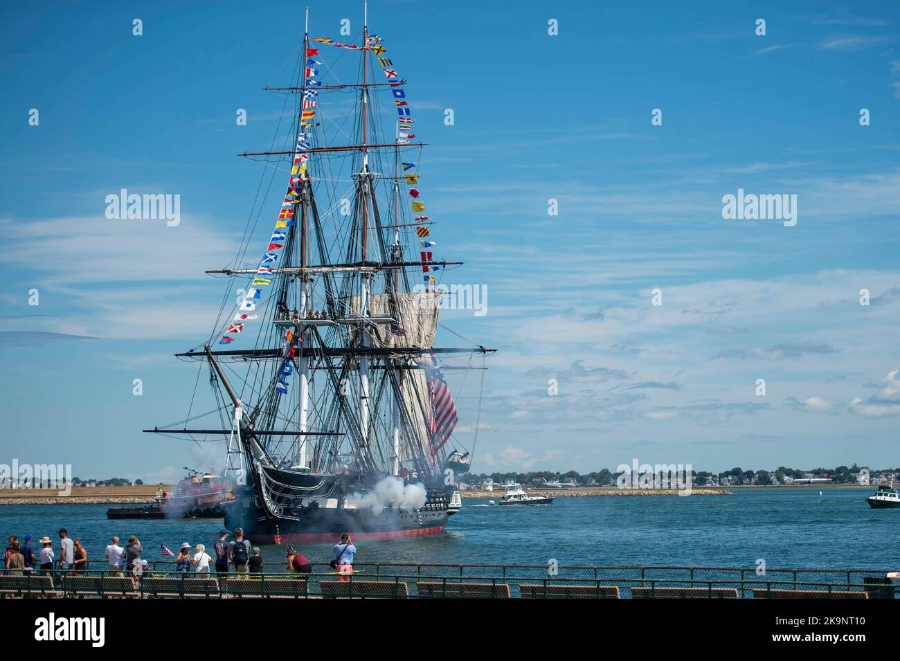 USS Constitution fires a 21-gun salute USS Constitution is the world’s oldest commissioned warship afloat and played a crucial role in the Barbary Wars and the War of 1812, actively defending sea lanes from 1797 to 1855. Stock Photo