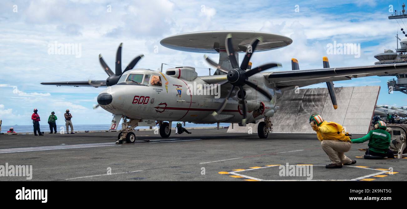 Northrop Grumman E-2 Hawkeye is an American all-weather, carrier-capable tactical airborne early warning (AEW) aircraft. Capt. Fred Goldhammer, commanding officer of the U.S. Navy’s only forward-deployed aircraft carrier USS Ronald Reagan (CVN 76), launches from the flight deck in an E-2D Hawkeye attached to the Tigertails of Airborne Early Warning Squadron (VAW) 125 Stock Photo