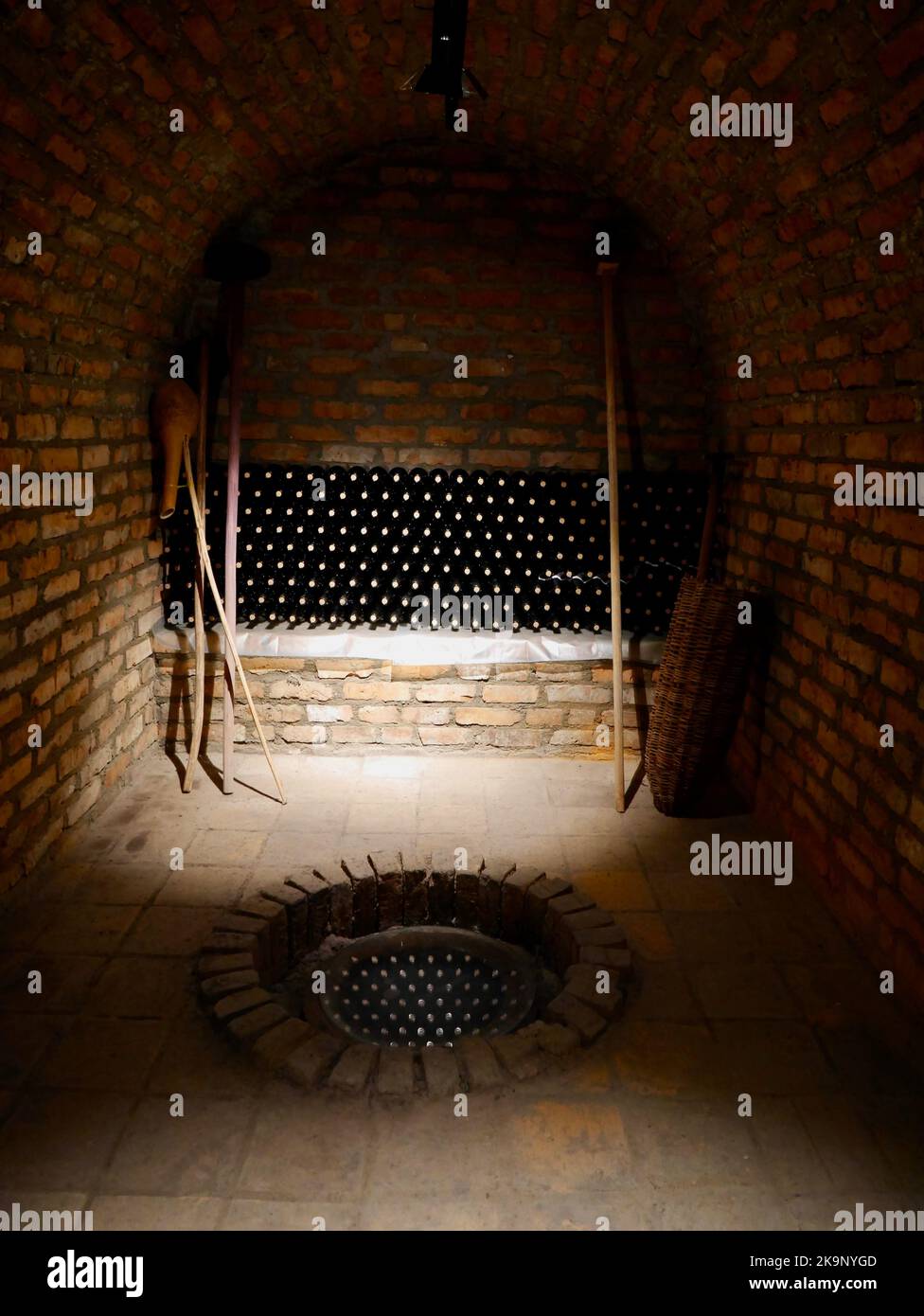 Stacked up bottles and hole in the floor for Kveri clay jugs in