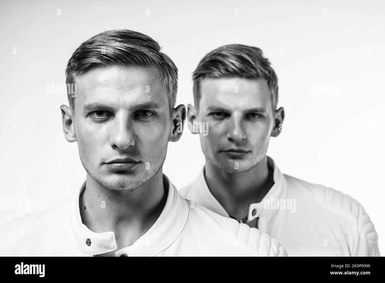 twin brothers men in white casual clothes look alike, brother Stock
