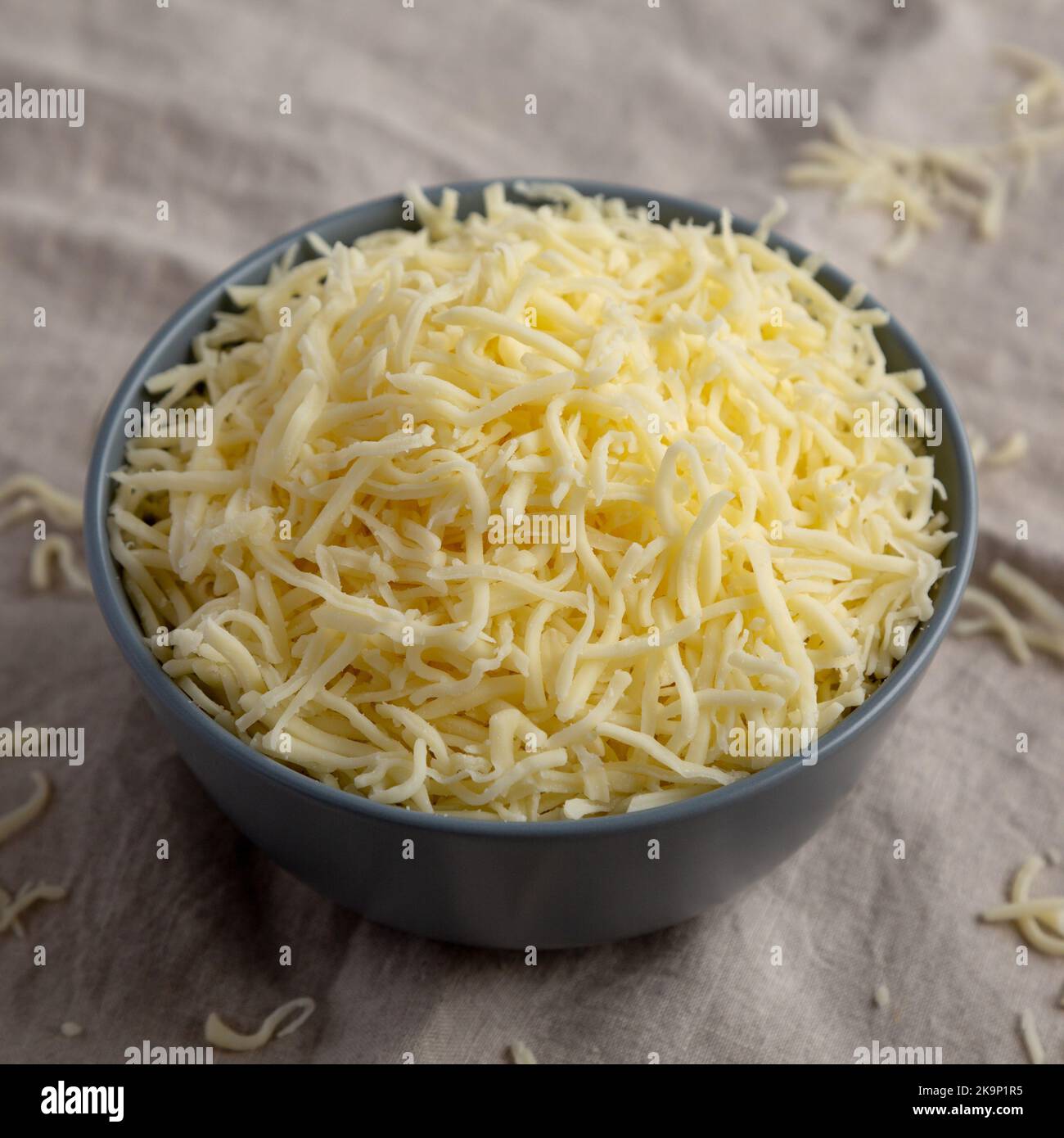 Shredded Mozzarella Cheese in a Plastic Container Stock Photo