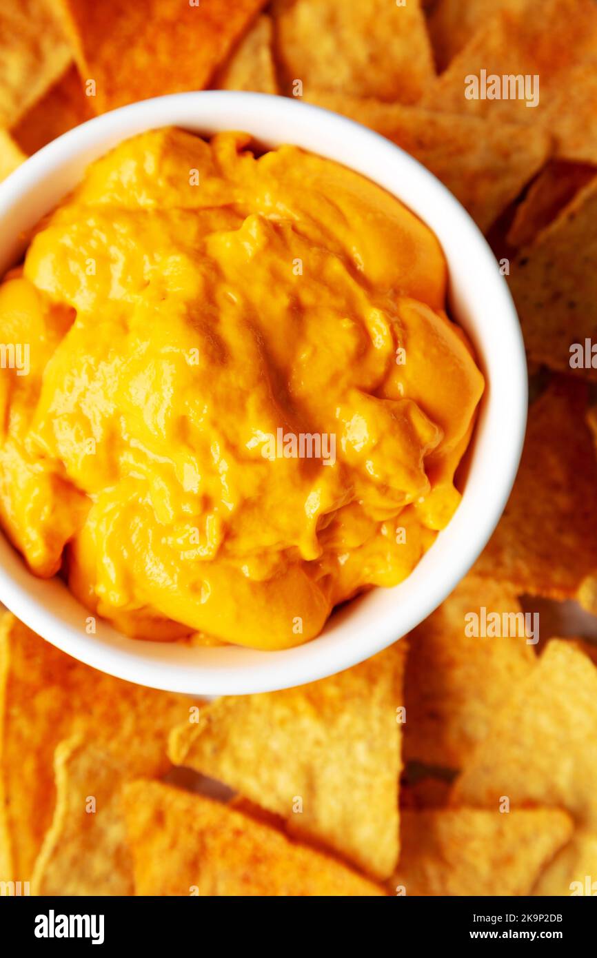Cheese dip with tortilla chips, top view. Flat lay, overhead, from ...