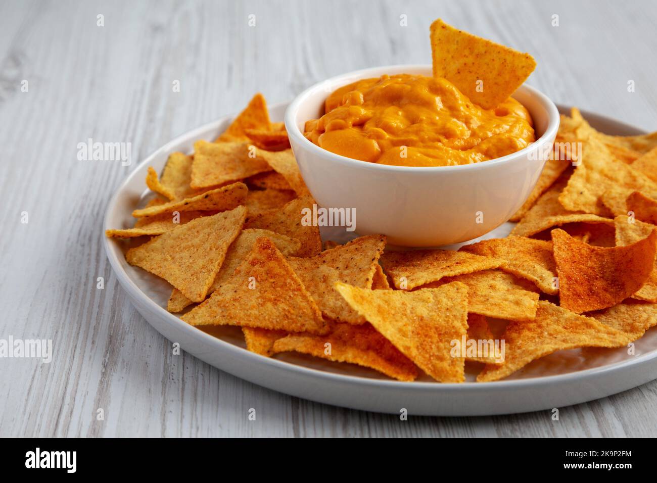 Cheese dip with tortilla chips, side view. Closeup Stock Photo Alamy