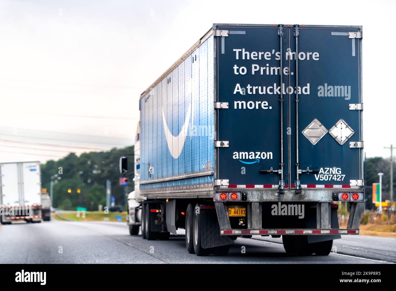 Greensboro, USA - January 7, 2021: North Carolina traffic highway road with driving truck for Amazon prime shipping delivery vehicle with Prime logo Stock Photo