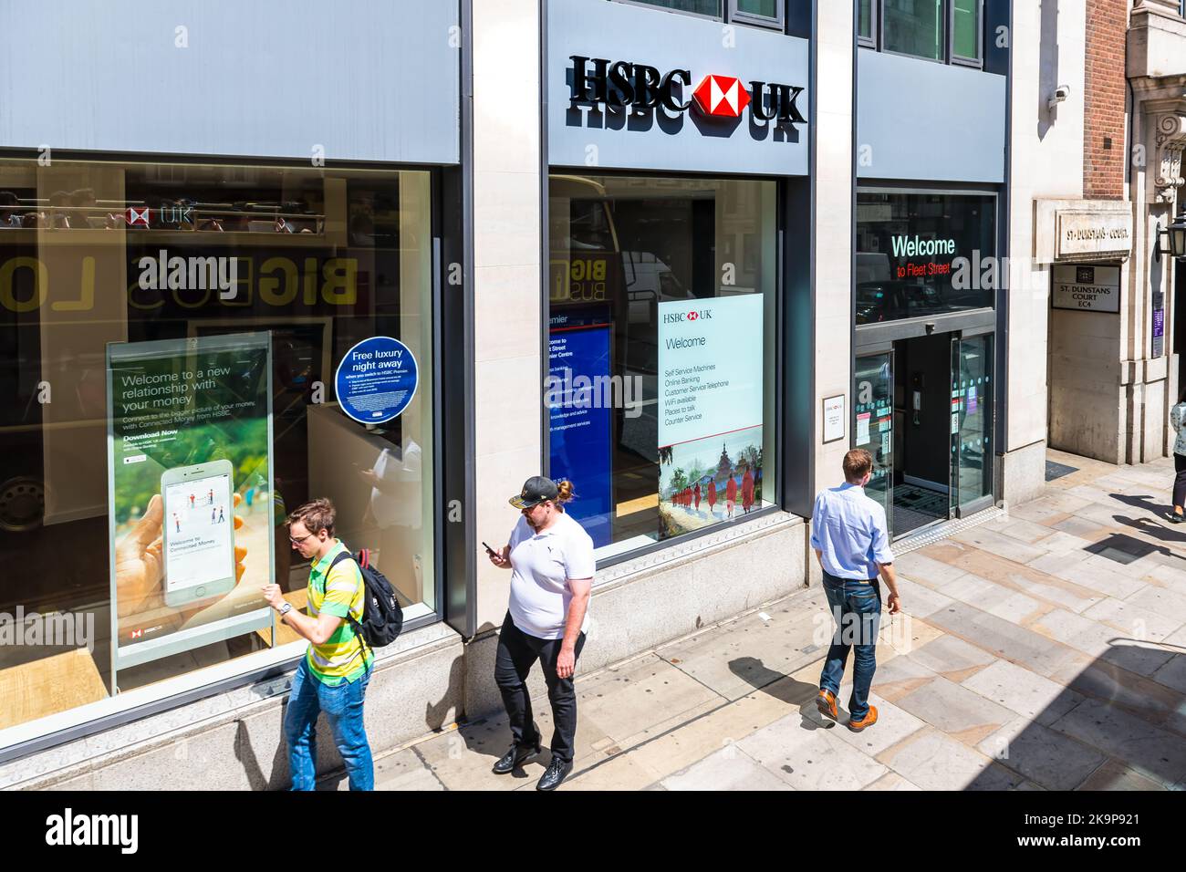London, United Kingdom - June 22, 2018: Above view on Fleet street sidewalk with business people walking by HSBC corporate bank office branch entrance Stock Photo