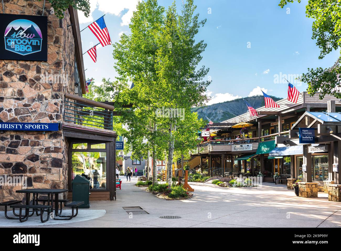 Aspen, USA - June 24, 2019: Snowmass village town city with strip shopping mall in Colorado downtown with sports store and Sotheby's real estate Stock Photo