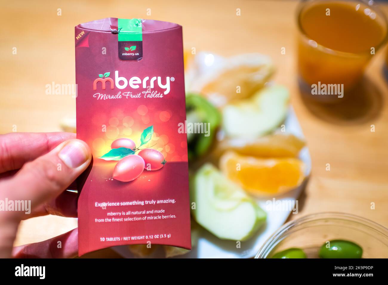 Durango, USA - September 2, 2019: Hand holding mberry miracle berry ledidi Synsepalum dulcificum berry brand tablet that turns sour food to sweet Stock Photo