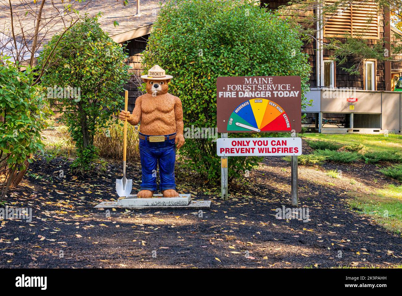 Kittery, ME - Oct. 19, 2022: Smokey the Bear stands beside a Maine Forestry Service Fire Danger Today sign with 'Only You Can Prevent Forest Fires' at Stock Photo