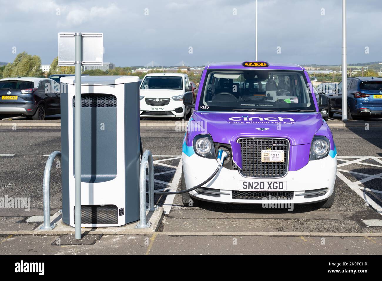 Electric taxi at an electric vehicle charging point at Ingliston Park