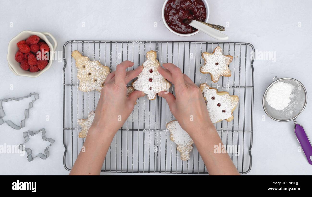 Christmas shortbread cookies with raspberry jam recipe, close up baking ...