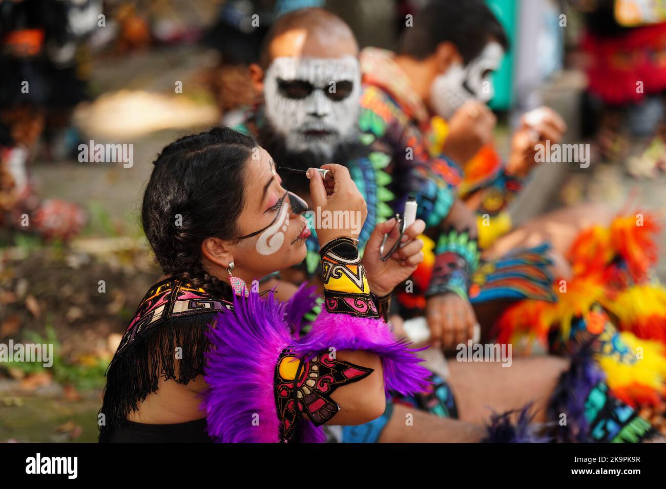 Mexico City, Mexico. 29th Oct, 2022. An indigenous dancer prepares her makeup before participating in the Grand Parade of the Dead to celebrate Dia de los Muertos holiday on Paseo de la Reforma, October 29, 2022 in Mexico City, Mexico. Credit: Richard Ellis/Richard Ellis/Alamy Live News Stock Photo