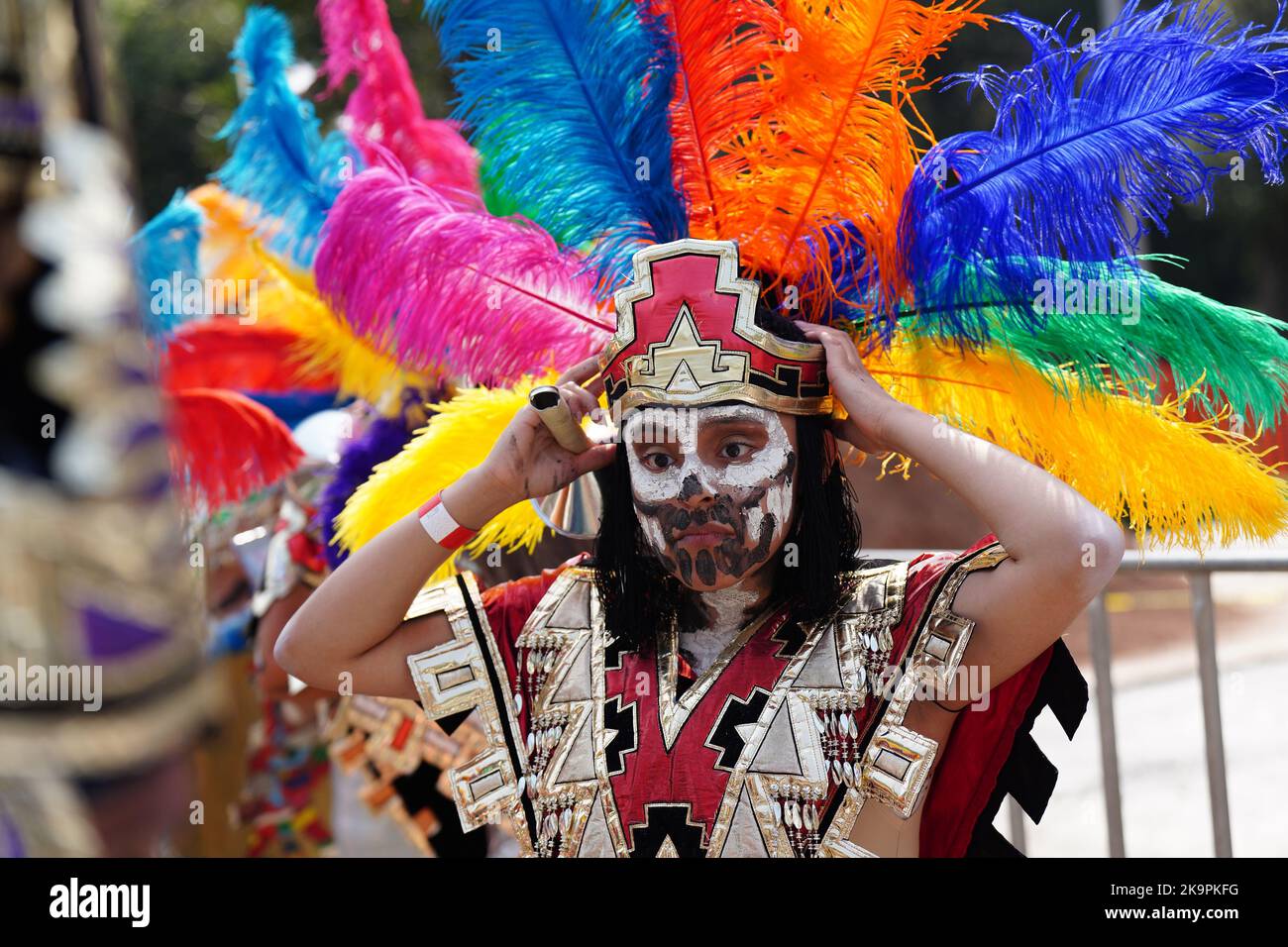 Mexico City, Mexico. 29th Oct, 2022. An indigenous dancer adjusts her head-dress before participating in the Grand Parade of the Dead to celebrate Dia de los Muertos holiday on Paseo de la Reforma, October 29, 2022 in Mexico City, Mexico. Credit: Richard Ellis/Richard Ellis/Alamy Live News Stock Photo