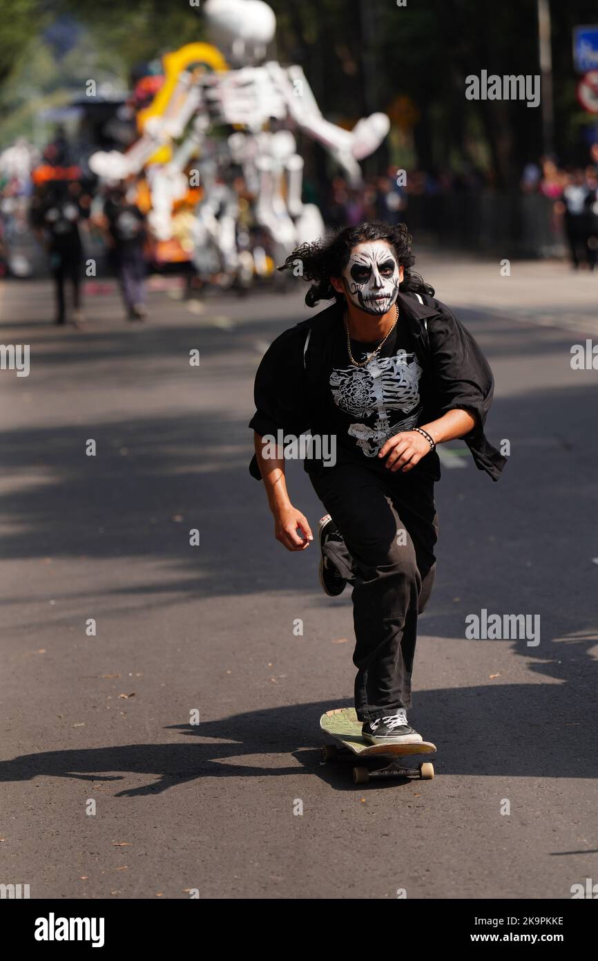 Mexico City, Mexico. 29th Oct, 2022. A skateboarder wearing a skeleton shirt rides his board down the street ahead of the floats during the Grand Parade of the Dead to celebrate Dia de los Muertos holiday on Paseo de la Reforma, October 29, 2022 in Mexico City, Mexico. Credit: Richard Ellis/Richard Ellis/Alamy Live News Stock Photo
