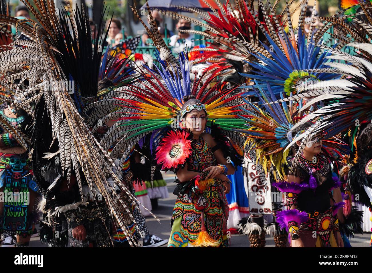 Mexico City, Mexico. 29th Oct, 2022. Indigenous costumed performers wait in the sun for the start of the Grand Parade of the Dead to celebrate Dia de los Muertos holiday on Paseo de la Reforma, October 29, 2022 in Mexico City, Mexico. Credit: Richard Ellis/Richard Ellis/Alamy Live News Stock Photo