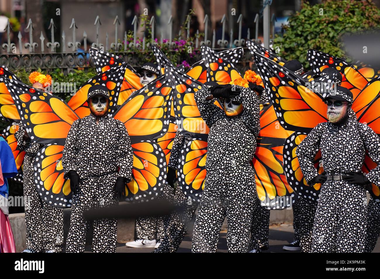 Mexico City, Mexico. 29th Oct, 2022. Monarch butterfly costumed performers wait in the sun for the start of the Grand Parade of the Dead to celebrate Dia de los Muertos holiday on Paseo de la Reforma, October 29, 2022 in Mexico City, Mexico. Credit: Richard Ellis/Richard Ellis/Alamy Live News Stock Photo